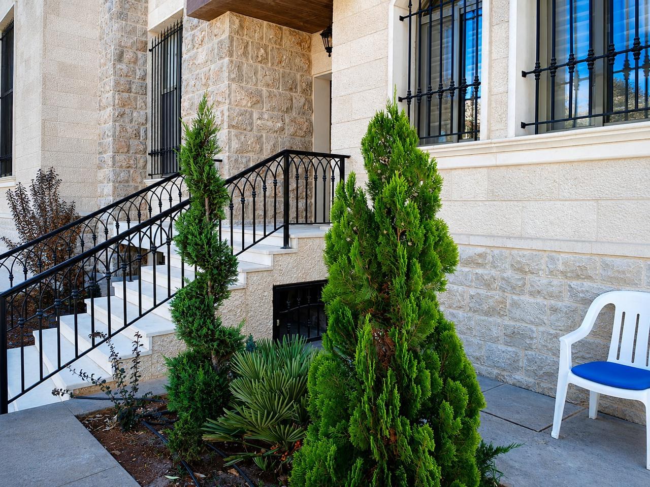 Spiral topiary lining a stone entrance staircase, Rachaya